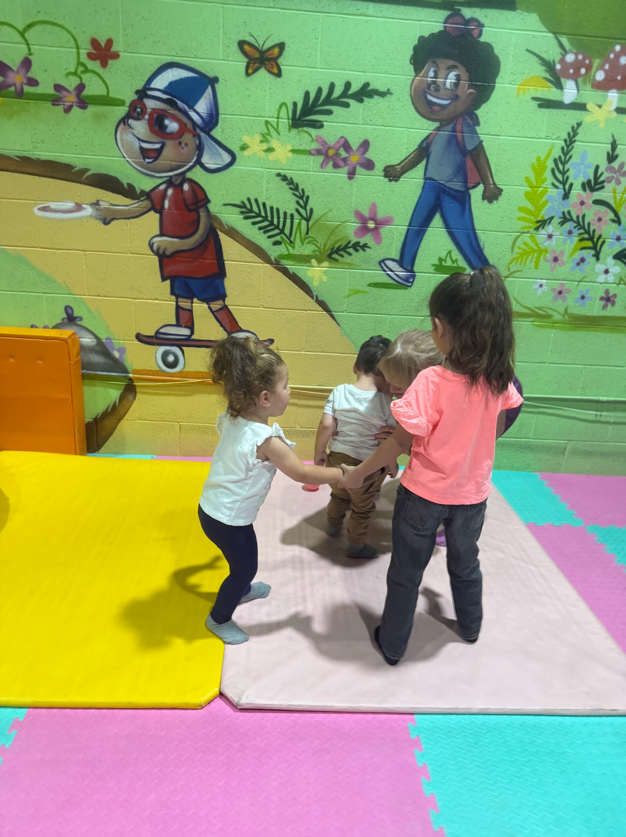 Children and adults gather for an activity in a group class.