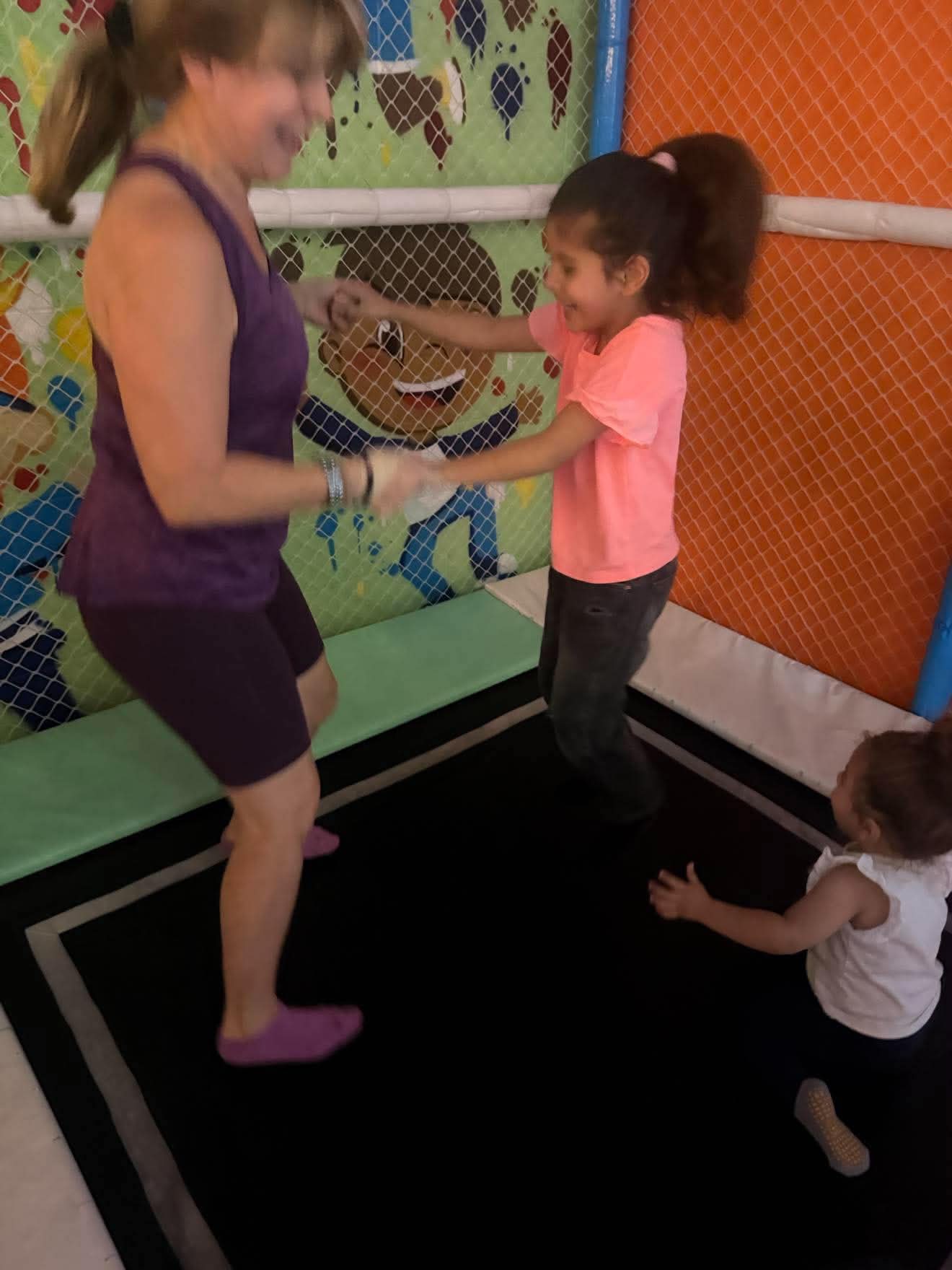 A child experiences a movement activity with an adult nearby.